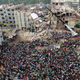 FILE - In this April 25, 2013, file photo, Bangladeshi people gather as rescuers look for survivors and victims at the site of a building that collapsed a day earlier, in Savar, near Dhaka, Bangladesh. A Bangladesh court on Monday, July 18, 2016, indicted 41 people for murder in the 2013 deaths of more than 1,100 people in the collapse of a building that housed five garment factories outside the capital. (AP Photo/A.M.Ahad, File)